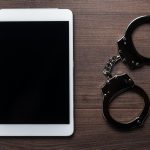 Handcuffs And Tablet Computer